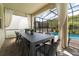 Outdoor dining area under a screened enclosure with a long table and seating for ten, perfect for entertaining at 2816 Simile St, Kissimmee, FL 34746