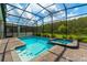 Sparkling screened pool and spa combination with brick paver deck and lush landscaping at 2816 Simile St, Kissimmee, FL 34746