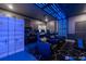 Exceptional theater room with recliner seating, stunning blue accent lighting, and cargo container décor at 2816 Simile St, Kissimmee, FL 34746