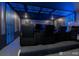 Captivating theater room with elevated seating, ambient blue lighting, and a large screen for immersive entertainment at 2816 Simile St, Kissimmee, FL 34746