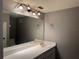 Bathroom features a large mirror, vanity with sink, and modern lighting at 304 Spring Run Cir, Longwood, FL 32779