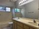Bright bathroom with double sinks, large mirror, and bathtub perfect for relaxation at 304 Spring Run Cir, Longwood, FL 32779