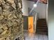 Entry foyer featuring a stacked stone accent wall and stairs to upper level at 304 Spring Run Cir, Longwood, FL 32779