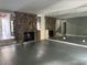 Open living space featuring a mirrored wall, stone fireplace, and access to the outdoors at 304 Spring Run Cir, Longwood, FL 32779