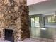 Spacious living area featuring stone fireplace, tile floors, and sliding glass doors at 304 Spring Run Cir, Longwood, FL 32779