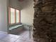 Cozy living room with a unique stone fireplace, built in seating, and tile flooring at 304 Spring Run Cir, Longwood, FL 32779