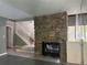 Bright living area showcasing a stone fireplace and stairway at 304 Spring Run Cir, Longwood, FL 32779