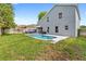 Backyard featuring a pool surrounded by a patio, green grass, and a wooden fence at 38 Jett Loop, Apopka, FL 32712