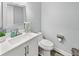 Half bathroom featuring a vanity, a silver framed mirror, and white walls at 38 Jett Loop, Apopka, FL 32712