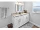 Bathroom with a double sink vanity, granite countertop, and a neutral color palette at 38 Jett Loop, Apopka, FL 32712