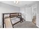 Neutral bedroom with a wooden bunk bed featuring a slide, ceiling fan, and plush gray carpet at 38 Jett Loop, Apopka, FL 32712