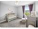 Bedroom featuring a neutral color palette, crib, and soft carpet at 38 Jett Loop, Apopka, FL 32712