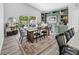 Open dining area with a rustic wood table, a built-in hutch, and sliding glass doors to the backyard at 38 Jett Loop, Apopka, FL 32712