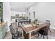 Bright dining area featuring a wooden table, modern chairs, and an open layout to the kitchen with bar seating at 38 Jett Loop, Apopka, FL 32712
