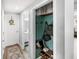 Hallway with a closet featuring decorative wallpaper, and a laundry room at 38 Jett Loop, Apopka, FL 32712