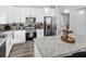 Modern kitchen with stainless steel appliances, white cabinets, and a large island at 38 Jett Loop, Apopka, FL 32712