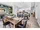 Open kitchen and dining area with a rustic table and modern island at 38 Jett Loop, Apopka, FL 32712