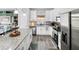Bright kitchen with stainless steel appliances, white cabinets, and granite countertops at 38 Jett Loop, Apopka, FL 32712