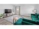 Bright and airy living room featuring wood-look floors, a large TV, and modern decor at 38 Jett Loop, Apopka, FL 32712