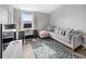 Bright living area with stylish couch, desk, and vibrant floral rug at 38 Jett Loop, Apopka, FL 32712
