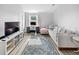 Inviting living room with desk, media center, and stylish floral rug at 38 Jett Loop, Apopka, FL 32712
