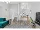 Bright living room featuring wood-look floors, stairs, and modern decor at 38 Jett Loop, Apopka, FL 32712