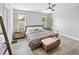 Bright main bedroom featuring two windows, wood-look floors, and stylish decor at 38 Jett Loop, Apopka, FL 32712