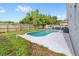 Backyard features a sparkling pool with a concrete deck and wood fence at 38 Jett Loop, Apopka, FL 32712
