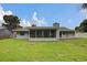 Spacious backyard featuring a screened patio and lush green lawn, perfect for outdoor activities and relaxation at 4217 Ilene Ct, Orlando, FL 32806