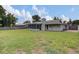 Large backyard showcasing a screened patio and green grass, creating a private outdoor oasis at 4217 Ilene Ct, Orlando, FL 32806