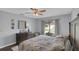 Comfortable bedroom with a ceiling fan, dresser, and window for natural lighting at 4217 Ilene Ct, Orlando, FL 32806