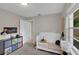 Bright bedroom featuring a crib, storage, and a window for natural light at 4217 Ilene Ct, Orlando, FL 32806