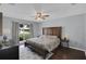 Inviting bedroom featuring a large bed, ceiling fan, and a window with natural light at 4217 Ilene Ct, Orlando, FL 32806