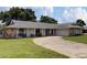 Angle view of a single story home with rock accents and a long driveway at 4217 Ilene Ct, Orlando, FL 32806