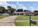 A view of the home with a long driveway, green lawn, mature trees and mailbox at 4217 Ilene Ct, Orlando, FL 32806