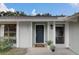 Inviting front entrance with a navy door, house number and decorative potted plants at 4217 Ilene Ct, Orlando, FL 32806