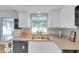 Kitchen sink and countertops, white cabinetry, window view and bright light at 4217 Ilene Ct, Orlando, FL 32806