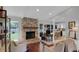 Open-concept living space featuring a cozy fireplace and a glimpse into the kitchen at 4217 Ilene Ct, Orlando, FL 32806