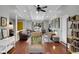 A living area with wood floors, white beamed ceilings, yellow door and comfortable seating at 4217 Ilene Ct, Orlando, FL 32806