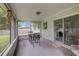 Enclosed patio with seating provides a relaxed outdoor living space with views of the backyard at 4217 Ilene Ct, Orlando, FL 32806