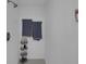 Close up of a tiled shower with rainfall showerhead and corner shelving for toiletries and bathroom accessories at 4217 Ilene Ct, Orlando, FL 32806