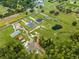 Aerial view showcasing the home's location near a pond, in a rural setting at 4266 La Salle Ave, St Cloud, FL 34772