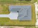 New construction home features a modern gray roof, paver driveway, and lush green surroundings at 4266 La Salle Ave, St Cloud, FL 34772