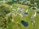 Aerial view of a new home in a large lot with neighboring properties and a serene pond at 4266 La Salle Ave, St Cloud, FL 34772