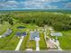Aerial shot of property featuring a new home, green landscape, and nearby wooded areas at 4266 La Salle Ave, St Cloud, FL 34772