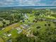 Aerial view of a home in a rural setting, with a nearby lake and green fields at 4266 La Salle Ave, St Cloud, FL 34772