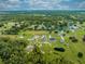 Wide aerial view of a home with sprawling greenery, neighboring houses, and distant trees at 4266 La Salle Ave, St Cloud, FL 34772