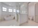 This bright bathroom features a soaking tub, glass enclosed shower, and a modern toilet at 4266 La Salle Ave, St Cloud, FL 34772