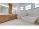This stunning bathroom features a soaking tub, double vanities, and lots of natural light at 4266 La Salle Ave, St Cloud, FL 34772