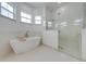 This bathroom features a soaking tub, glass enclosed shower, and bright windows at 4266 La Salle Ave, St Cloud, FL 34772